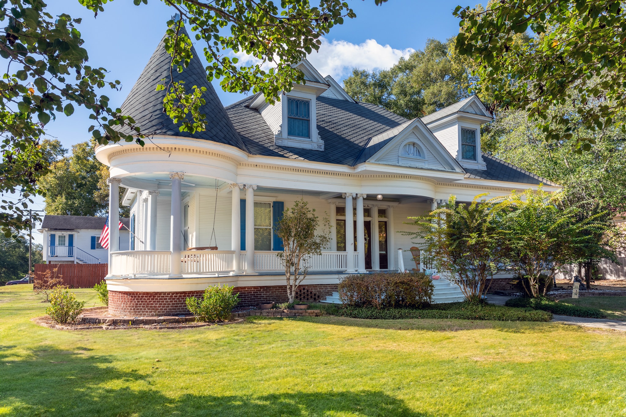 Classic white farmhouse with wraparound porch