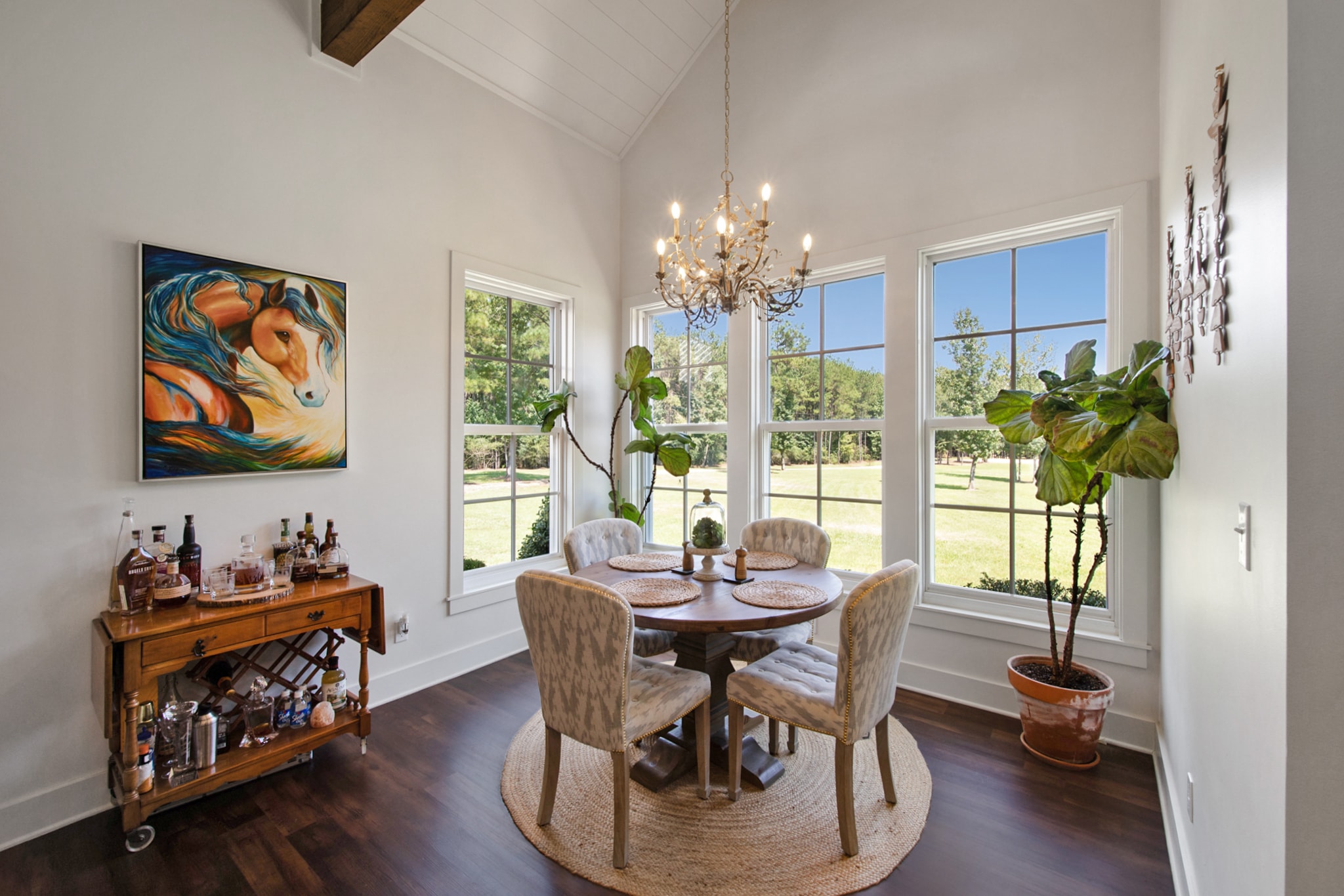 Bright dining room with round table and chandelier